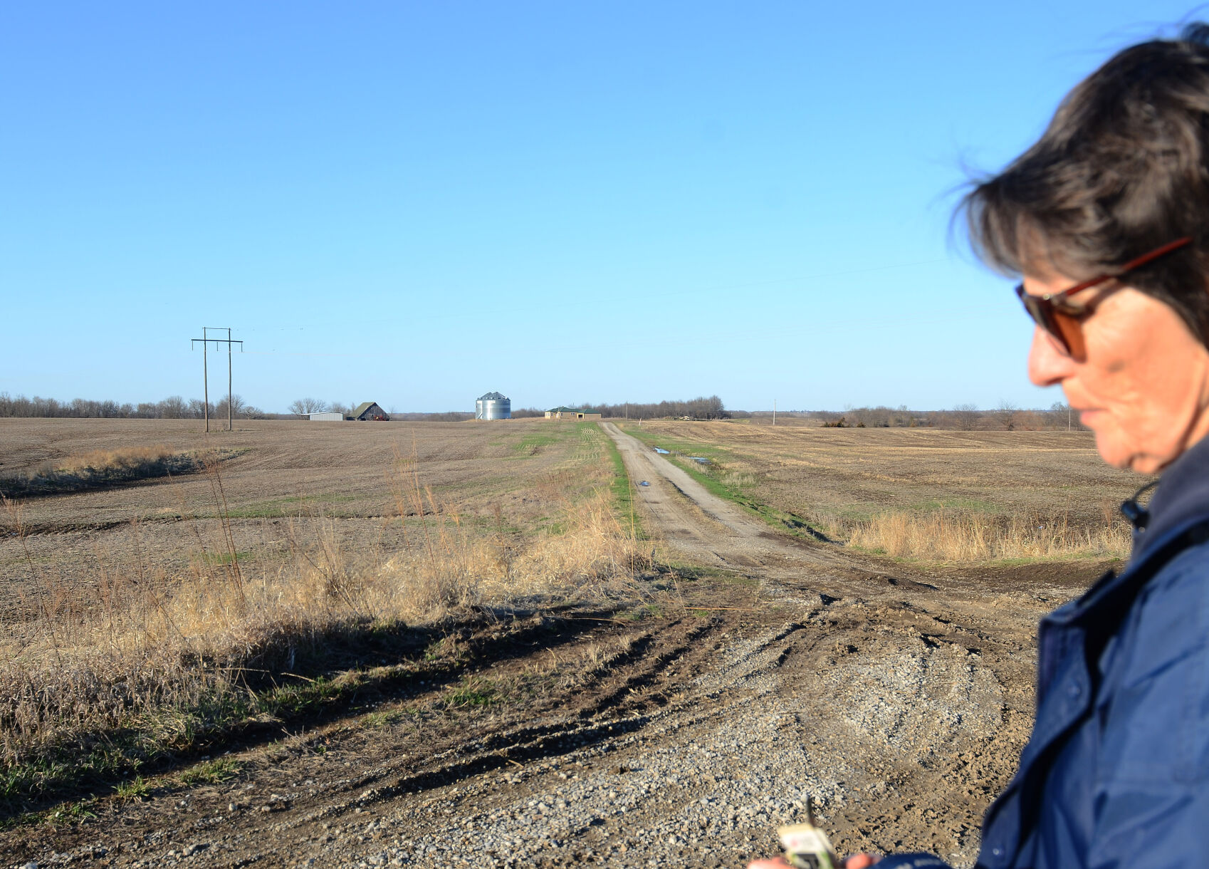 Susan Fair stands in front of the permitted CAFO land